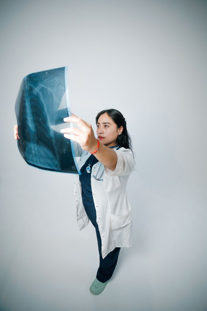 Medical professional examining an X-ray. High-quality healthcare imagery for clinical use.